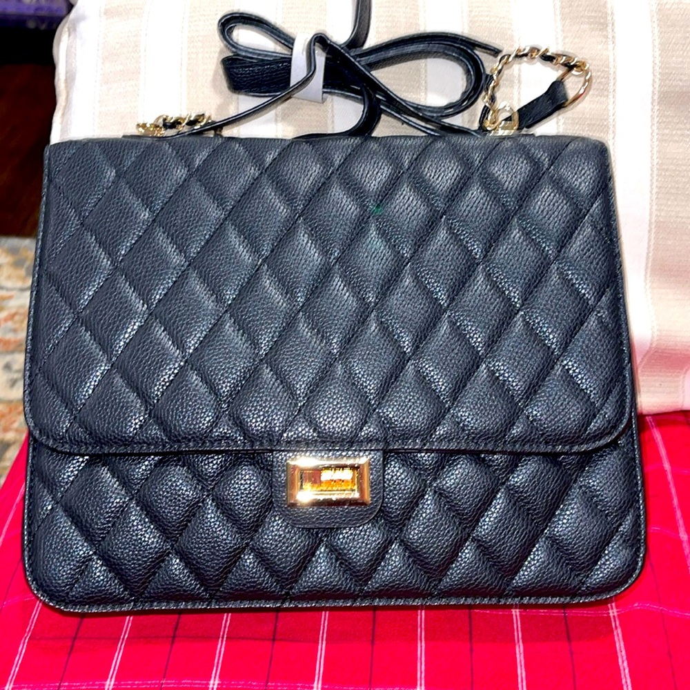 Square design backpack in matte black pu leather.